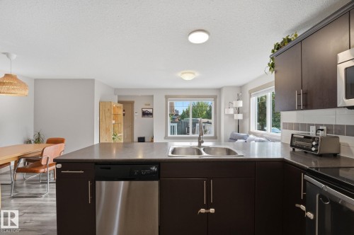 Kitchen with L shape counter a double-basin sink and stainless steel dishwasher - 17621 10 Avenue Sw, Edmonton, AB - Indoor Photo Showing Kitchen With Double Sink