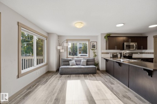 Open-concept living space featuring ample natural light from multiple windows - 17621 10 Avenue Sw, Edmonton, AB - Indoor
