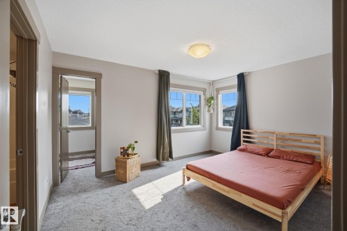 Spacious bedroom featuring two windows - 17621 10 Avenue Sw, Edmonton, AB - Indoor Photo Showing Bedroom