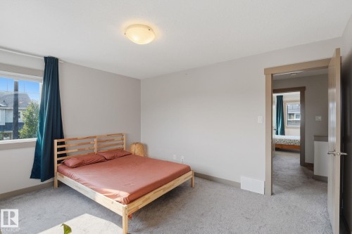Spacious bedroom featuring large windows - 17621 10 Avenue Sw, Edmonton, AB - Indoor Photo Showing Bedroom