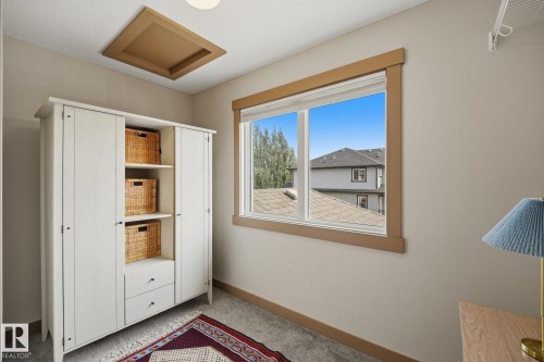 spacious walk-in closet with a large window for natural light - 17621 10 Avenue Sw, Edmonton, AB - Indoor Photo Showing Other Room
