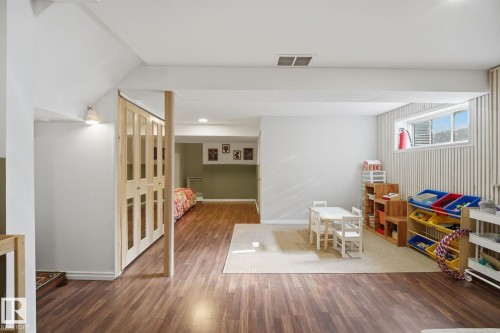 Lower level featuring wood-finish flooring - 17621 10 Avenue Sw, Edmonton, AB - Indoor Photo Showing Other Room