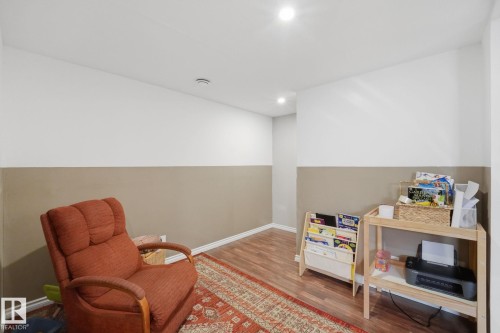 Recessed lighting illuminates wood-finish flooring with white baseboards - 17621 10 Avenue Sw, Edmonton, AB - Indoor
