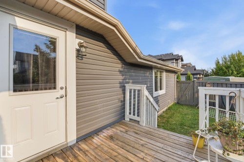 Wood-finish decking with white railing and steps - 17621 10 Avenue Sw, Edmonton, AB - Outdoor With Exterior