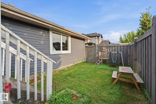 Private fenced backyard featuring gate access, and a wooden fence - 17621 10 Avenue Sw, Edmonton, AB - Outdoor