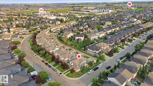 Aerial perspective showcasing a residential neighborhood with varied architectural styles and mature street trees - 17621 10 Avenue Sw, Edmonton, AB - Outdoor With View