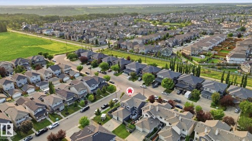 Aerial overview of a residential neighborhood with varied architectural styles and mature landscaping - 17621 10 Avenue Sw, Edmonton, AB - Outdoor With View