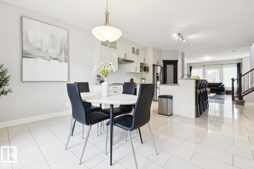 Open-concept living area with white tile flooring - 9919 79 Street Nw, Edmonton, AB 