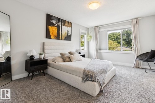 Recessed lighting, light gray wall paint, large windows, and carpet flooring - 9919 79 Street Nw, Edmonton, AB 