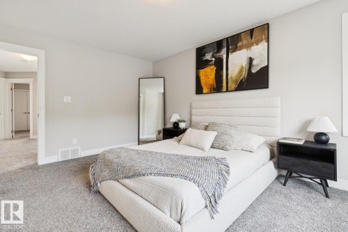 Neutral wall color, plush carpet flooring, recessed lighting, white trim, and a white door frame - 9919 79 Street Nw, Edmonton, AB 