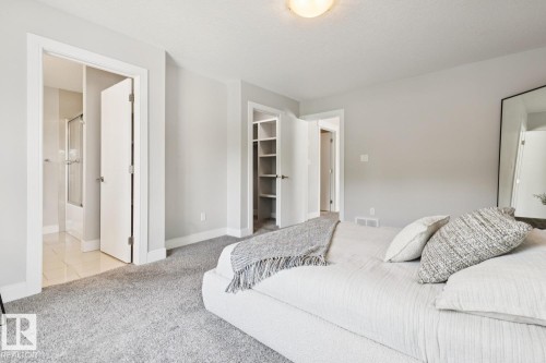 Plush carpeting, light-colored wall paint, recessed lighting, and built-in closet shelving - 9919 79 Street Nw, Edmonton, AB 