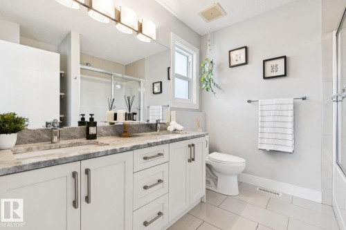 Dual vanity with undermount sinks and gray stone-finish countertop - 9919 79 Street Nw, Edmonton, AB 