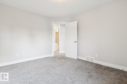 Plush gray carpeting and white trim complement light gray wall paint - 9919 79 Street Nw, Edmonton, AB 