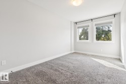 Light gray carpeting with white baseboards - 