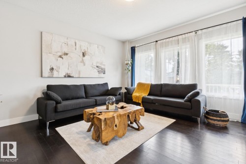 Dark wood-finish flooring with white baseboards - 9919 79 Street Nw, Edmonton, AB 
