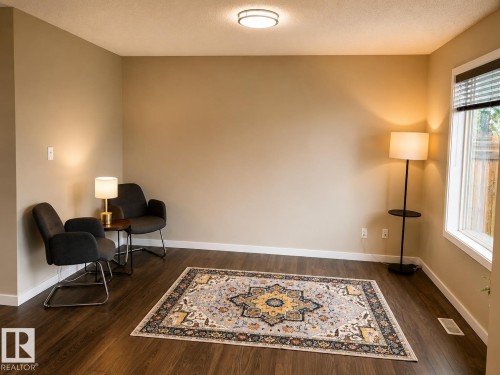 Wood-finish flooring with neutral wall tones - 5407 14 Avenue Sw, Edmonton, AB 