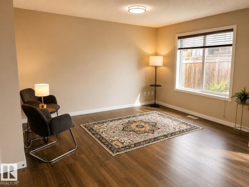 Wood-finish flooring with neutral wall tones - 5407 14 Avenue Sw, Edmonton, AB 
