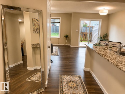 Wood-finish flooring throughout, light neutral wall tones, and recessed lighting - 5407 14 Avenue Sw, Edmonton, AB 