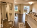 Wood-finish flooring throughout, light neutral wall tones, and recessed lighting - 5407 14 Avenue Sw, Edmonton, AB 