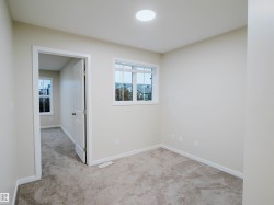 Neutral wall paint, recessed ceiling lighting, and carpet flooring - 