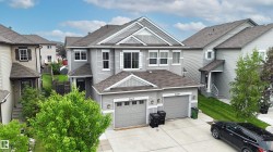Multi-level architectural design with gray siding - 
