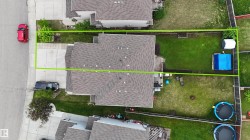 Expansive residential lot featuring mature landscaping, manicured lawn, and established trees - 