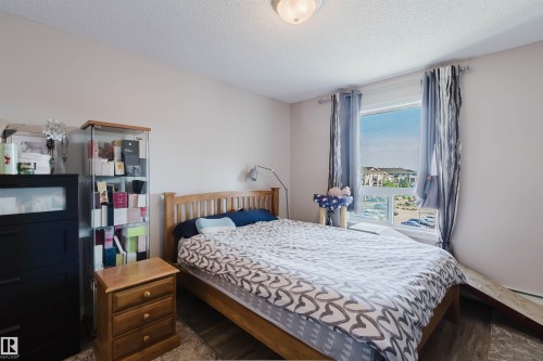 Bright room featuring a large window, recessed lighting, and wood-finish flooring - #7428 7327 South Terwillegar Dr Nw, Edmonton, AB 