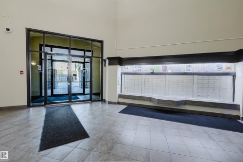 Tiled flooring, glass paneled entry doors, and built-in mailboxes - #7428 7327 South Terwillegar Dr Nw, Edmonton, AB 