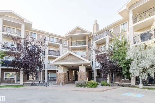 Multi-story building with multiple private balconies featuring black wrought iron railings - #7428 7327 South Terwillegar Dr Nw, Edmonton, AB 