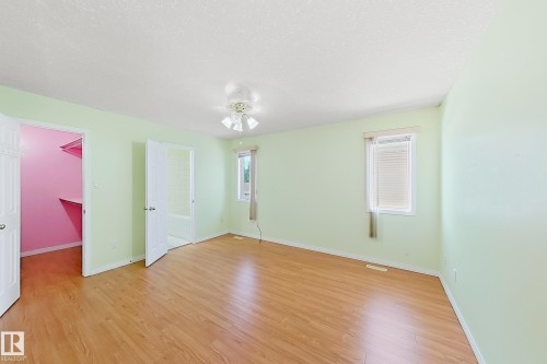 Wood-finish flooring throughout, two windows with blinds, and a built-in ceiling fan with integrated lighting - 3015 37 Street Nw, Edmonton, AB 