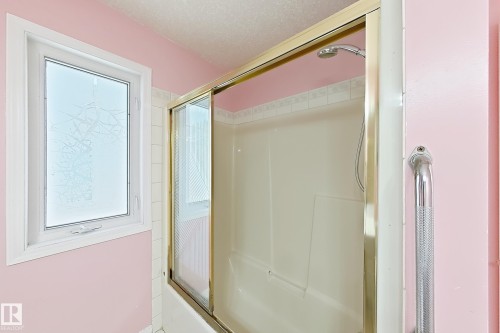 Shower-tub combination with sliding glass doors and a wall-mounted shower head - 3015 37 Street Nw, Edmonton, AB 