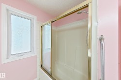 Shower-tub combination with sliding glass doors and a wall-mounted shower head - 
