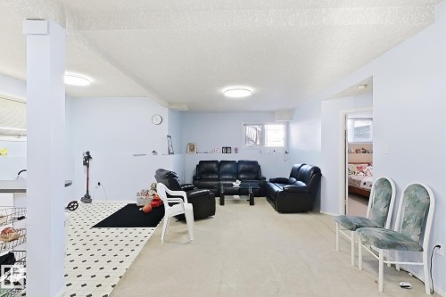 Recessed lighting, light-toned carpeting, and a contrasting black and white tiled area - 3015 37 Street Nw, Edmonton, AB 