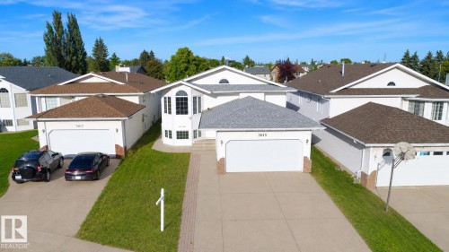 Two-story residence with a light-colored exterior and a multi-pane bay window - 3015 37 Street Nw, Edmonton, AB 