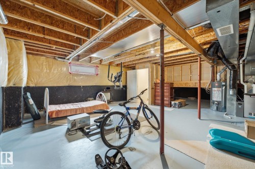 Basement area with exposed ceiling joists, concrete flooring, and visible insulation - 1709 Turvey Bend Bend Nw, Edmonton, AB 