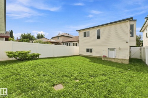 Expansive lawn area, durable vinyl fencing, bay window feature, multiple windows, and a lower-level entry - 1709 Turvey Bend Bend Nw, Edmonton, AB 