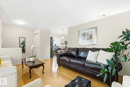 Varnished wood-finish flooring, vaulted ceiling, and recessed lighting fixtures - 1709 Turvey Bend Bend Nw, Edmonton, AB 