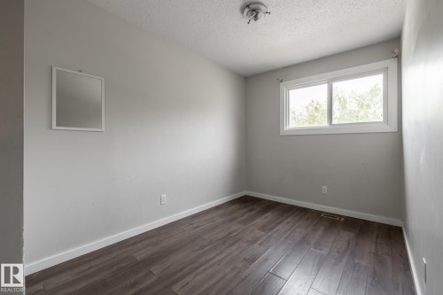 Neutral-toned walls complementing wood-finish flooring - 54 Lakewood Village Nw, Edmonton, AB 