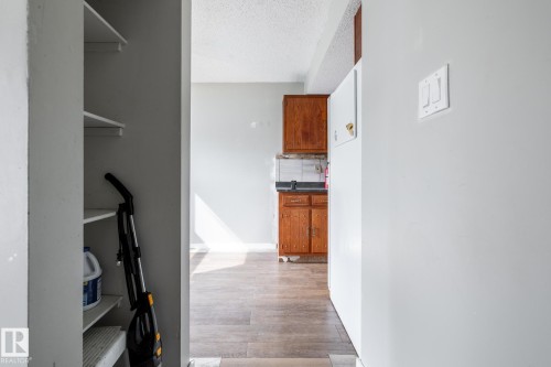 Built-in shelving, wood-finish flooring, and kitchen cabinetry - 54 Lakewood Village Nw, Edmonton, AB 