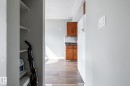 Built-in shelving, wood-finish flooring, and kitchen cabinetry - 54 Lakewood Village Nw, Edmonton, AB 