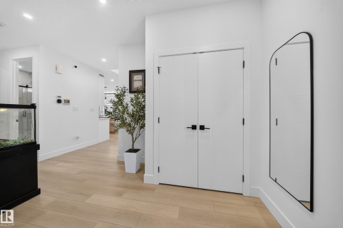 Wood-finish flooring throughout, white interior walls, and recessed lighting - 17128 2 Street Nw, Edmonton, AB 