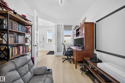 Main Floor Bedroom with double doors, window & closet. - 17128 2 Street Nw, Edmonton, AB 