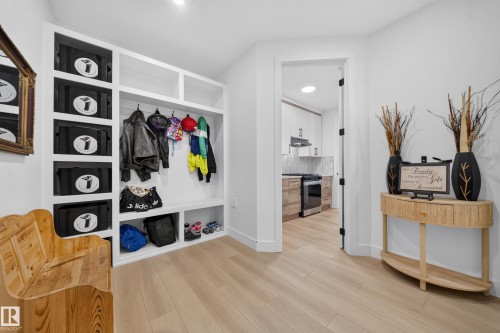 Built-in storage solutions with shelving, coat hooks, and bench seating - 17128 2 Street Nw, Edmonton, AB 