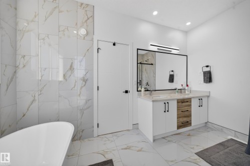 Dual vanity with integrated sinks and a large framed mirror - 17128 2 Street Nw, Edmonton, AB 