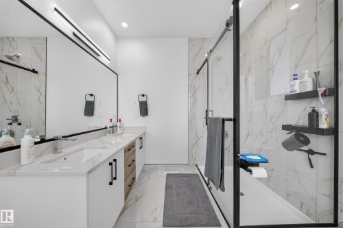 Dual vanity with white undermount sinks and light-toned countertops - 17128 2 Street Nw, Edmonton, AB 