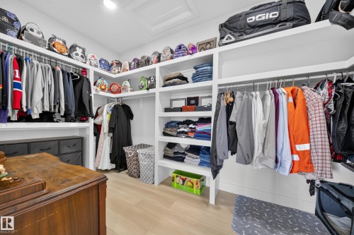 Built-in custom shelving, integrated hanging rods, recessed lighting, and wood-finish flooring - 17128 2 Street Nw, Edmonton, AB 