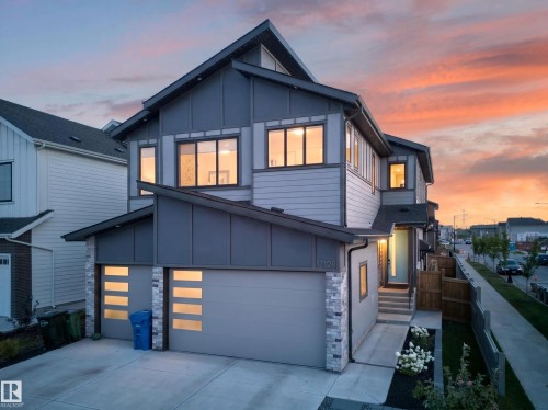 Modern architectural exterior featuring multiple gables, horizontal siding, and stone accents - 17128 2 Street Nw, Edmonton, AB 