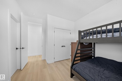 Wood-finish flooring, white walls, and white trim - 17128 2 Street Nw, Edmonton, AB 