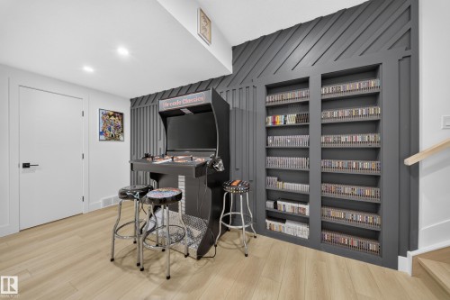 Storage shelf wall that also doubles as secret doors, leading to an office room & a full theatre room! - 17128 2 Street Nw, Edmonton, AB 