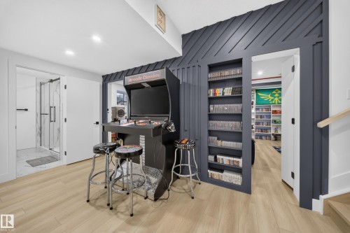 Storage shelf wall that also doubles as secret doors, leading to an office room & a full theatre room! - 17128 2 Street Nw, Edmonton, AB 